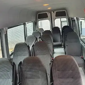 the interior of a bus with many seats