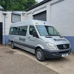 a silver van parked in front of a building